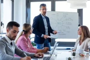 Handsome businessman explaining a project to his colleagues on coworking place.